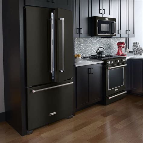 black stainless steel kitchen appliances with wood cabinets|black fridge in white kitchen.